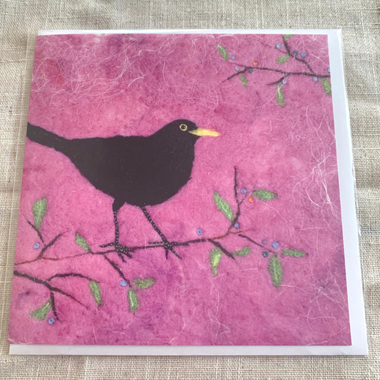 Blackbird - square card from an original felting by Rowena Scotney  £3.50  148.0mm x 148.0mm  Square card of an original felting inspired by a singing blackbird in the tops of the tree in my garden. It is also inspired by the poem ‘may my heart always be open to little birds’ by e.e. cummings.  The poem is printed on the back of the card.&nbsp;  The original was created firstly with wet-felted base layers and then further layers of needle-felting and fibres were added for depth and texture. 