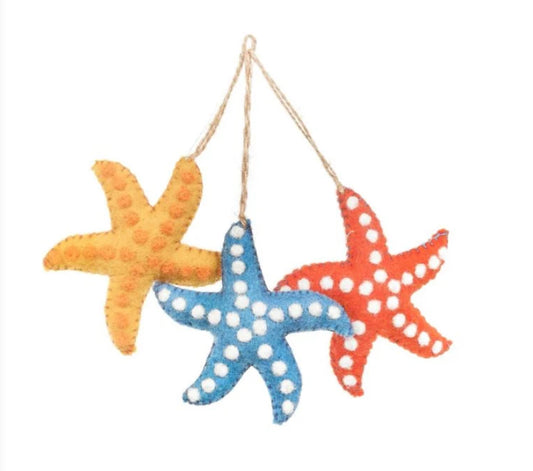 Handmade Felted Starfish Hanging Decoration.  £5  Available in sunshine yellow, paradise orange and ocean blue, all with delicate white detailing.&nbsp;  Just one of a super cute variety of felt decorations we have in store.  Dimensions: H9.5cm x W9.5cm  Material: 100% wool  Suitable from: 3 years  Eco friendly &amp; biodegradable  This is a fair trade item made in Nepal