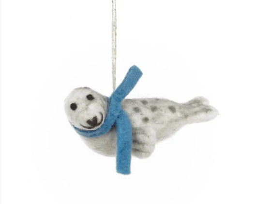 Handmade Felted Seal Hanging Decoration  £16  Eduardo the seal is sporting a cosy blue scarf  Just one of many super cute felted decorations we have in store.  Dimensions: 5cm x 10.5cm Material: 100% wool  Eco friendly &amp; Bio degradable. Suitable from: 3 years  This is a fair trade product from Nepal Shop fair trade, shop small, shop independent, Seawitch Stores, Mousehole,